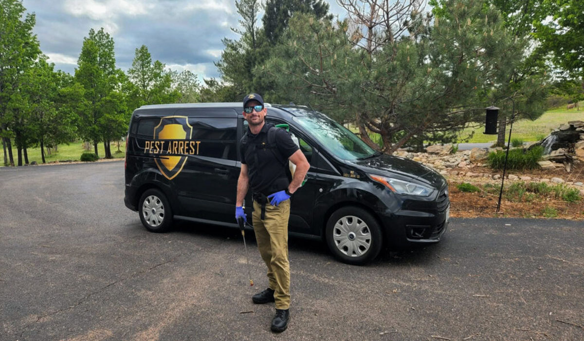 Pest Arrest truck behind a pest control professional